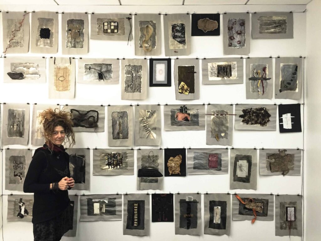 Image of Paz Perlman with an exhibition of her works